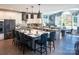 Modern kitchen featuring an island, pendant lighting, gray cabinetry, and views to the outdoor dining area at 841 Lake Forest Dr # Hawthorne, Belmont, NC 28012