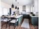 Modern kitchen featuring a large island, pendant lighting, white cabinetry, and stainless steel appliances at 841 Lake Forest Dr # Hawthorne, Belmont, NC 28012