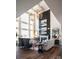 Stunning living room with fireplace, modern chandeliers, and expansive windows offering plenty of natural light at 841 Lake Forest Dr # Hawthorne, Belmont, NC 28012