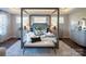 Beautiful bedroom featuring a four-poster bed, natural light, and comfortable seating at 841 Lake Forest Dr # Hawthorne, Belmont, NC 28012