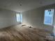 Spacious bedroom with hardwood floors and large windows at 715 Charles Ave, Charlotte, NC 28205