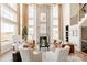 Living room showcasing soaring ceilings, a fireplace, ample natural light, and modern furnishings at 843 Lake Forest Dr # Devonshire, Belmont, NC 28012