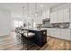 Modern, well-lit kitchen featuring a large island, white cabinets, and stainless steel appliances at 5217 Glenwalk Dr # 0059, Charlotte, NC 28269