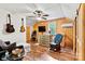 Inviting bedroom area with wood paneling, a decorative chest of drawers, and a comfortable rocking chair at 6051 Pointe West Ln, Vale, NC 28168