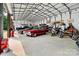 Large garage space showcasing a variety of vehicles, including cars and motorcycles, providing ample parking at 6051 Pointe West Ln, Vale, NC 28168