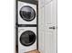 Efficient laundry area with a stacked washer and dryer unit at 6051 Pointe West Ln, Vale, NC 28168