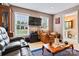 Comfortable living room featuring plush seating, natural light, and hardwood flooring at 6051 Pointe West Ln, Vale, NC 28168