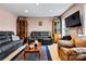 Cozy living room featuring modern furniture, hardwood flooring, and a large flat-screen TV at 6051 Pointe West Ln, Vale, NC 28168