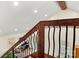 Elegant staircase featuring wooden railings and a view of the bright living space below at 6051 Pointe West Ln, Vale, NC 28168