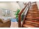 Wooden staircase with decorative metal railings leading to the upper level, adjacent to the living area at 6051 Pointe West Ln, Vale, NC 28168