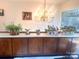 Bright dining room showcasing a chandelier, countertop space, plants, and an expansive window view at 2535 Fairfax Dr, Gastonia, NC 28054