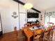 Well-lit dining room with a wooden table set for a meal, decorative plates, and ample space for entertaining guests at 2535 Fairfax Dr, Gastonia, NC 28054