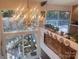 Sunlit foyer showing the staircase, a striking chandelier, and a large window displaying the outdoor scenery at 2535 Fairfax Dr, Gastonia, NC 28054