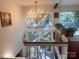 A luminous chandelier hangs above the foyer, complemented by a sizable window overlooking trees and a white staircase at 2535 Fairfax Dr, Gastonia, NC 28054