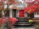 Charming home featuring a bold red front door, unique architectural details, and beautifully landscaped front entrance at 2535 Fairfax Dr, Gastonia, NC 28054