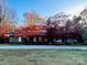 Inviting home with a well-maintained lawn, colorful landscaping, and a long driveway leading to the front entrance at 2535 Fairfax Dr, Gastonia, NC 28054