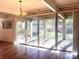 Spacious living room featuring wood flooring, large glass doors to the back patio, and a chandelier at 2535 Fairfax Dr, Gastonia, NC 28054