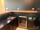 Interior wet bar features a wine cooler, sink and black cabinetry at 2535 Fairfax Dr, Gastonia, NC 28054