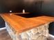 Interior entertainment area features a stone wet bar with rustic wood countertop at 2535 Fairfax Dr, Gastonia, NC 28054