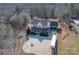 Aerial view of a large home, showcasing the expansive lot, private driveway and surrounding trees at 1491 Hwy 160 E Rd, Fort Mill, SC 29715