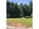 The backyard is surrounded by mature trees and a shed for ample storage at 1491 Hwy 160 E Rd, Fort Mill, SC 29715
