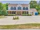 Stately two-story home with a full front porch, lush landscaping, and ample parking space at 1491 Hwy 160 E Rd, Fort Mill, SC 29715