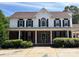 Traditional two-story home with a brick facade, white columns, and mature landscaping at 1491 Hwy 160 E Rd, Fort Mill, SC 29715