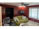 Comfortable living room with a green couch, accent wall, and ceiling fan at 1491 Hwy 160 E Rd, Fort Mill, SC 29715