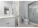 All-white bathroom features a standalone shower and a large vanity with plenty of storage at 4016 Nettie Ct, Charlotte, NC 28211