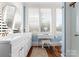 Bright bathroom featuring double vanity, white cabinets, modern mirror, and ample natural light at 4016 Nettie Ct, Charlotte, NC 28211