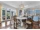 Charming dining area with French doors, wood floors, a modern table, and a stylish chandelier at 4016 Nettie Ct, Charlotte, NC 28211