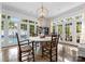 Bright dining area with French doors overlooking the pool, a modern table, and natural light at 4016 Nettie Ct, Charlotte, NC 28211