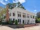 Elegant two-story home with striking white columns, black shutters, and a rooftop deck, perfect for entertaining at 4016 Nettie Ct, Charlotte, NC 28211