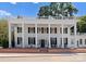 Stately home featuring a grand facade with white columns, dark shutters, a brick base, and a welcoming entrance at 4016 Nettie Ct, Charlotte, NC 28211