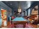 Sophisticated game room with a billiard table, custom lighting, and refined decor for entertainment and relaxation at 4016 Nettie Ct, Charlotte, NC 28211