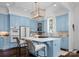 Bright kitchen featuring blue cabinetry, marble countertops, a central island, and stainless steel appliances at 4016 Nettie Ct, Charlotte, NC 28211