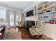 Cozy living room featuring a fireplace, built-in shelving, hardwood floors, and comfortable armchairs at 4016 Nettie Ct, Charlotte, NC 28211