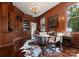 Wood-paneled living room with built-in shelves, large windows, and stylish decor, creating an inviting atmosphere at 4016 Nettie Ct, Charlotte, NC 28211