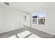 An airy bedroom with neutral carpet, natural light, and a view to the outside balcony at 1428 Hamilton St # 13, Charlotte, NC 28206