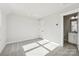 Bedroom with neutral walls and carpet, with a peek into the ensuite bathroom at 1428 Hamilton St # 13, Charlotte, NC 28206