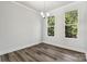 Bright dining area featuring hardwood floors, neutral paint, and natural light from two windows at 1428 Hamilton St # 13, Charlotte, NC 28206