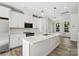 Bright modern kitchen featuring white cabinetry, stainless steel appliances, and a quartz countertop island at 1428 Hamilton St # 13, Charlotte, NC 28206