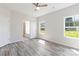 Bedroom with luxury vinyl plank flooring, a ceiling fan, and large windows overlooking backyard at 213 Sheffield Dr, York, SC 29745