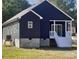 Rear view of a charming home featuring dark siding and a cozy covered porch with white railings at 213 Sheffield Dr, York, SC 29745