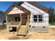 New construction home with covered porch and wooden steps at 213 Sheffield Dr, York, SC 29745