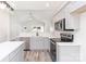 Modern kitchen boasts gray cabinets, stainless steel appliances, and a seamless open-concept design at 213 Sheffield Dr, York, SC 29745