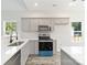 Modern kitchen featuring gray cabinets, stainless steel appliances, and bright countertops with natural light at 213 Sheffield Dr, York, SC 29745