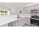 Modern kitchen featuring stainless steel appliances, quartz countertops, and an eat-in bar at 213 Sheffield Dr, York, SC 29745