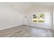 Inviting living room with sleek floors, a bright window, and neutral walls for a comfortable ambiance at 213 Sheffield Dr, York, SC 29745