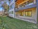 Backyard showcasing a stone-clad patio area, a lush lawn, and a modern home facade at 914 Laurel Creek Ln, Charlotte, NC 28211
